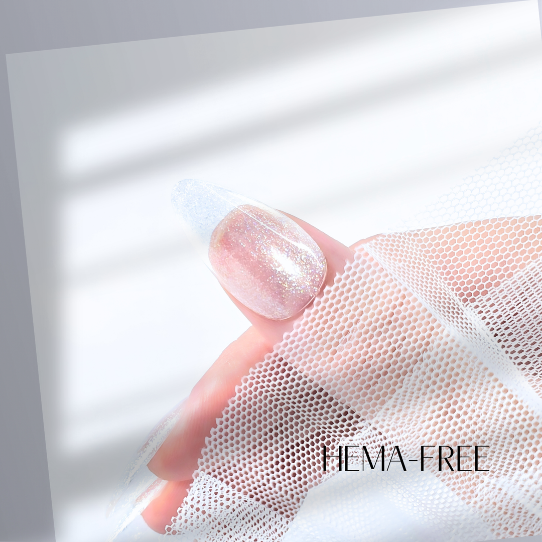 A close-up of a thumb painted with White Diamond Nails gel polish in Sooo Pretty, shade 311, featuring a sheer white finish with a soft glittery shimmer, offering a delicate and luminous effect, set against a clean, modern background.