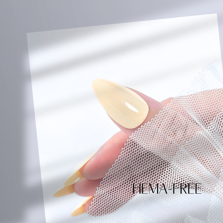 A close-up of a thumb painted with White Diamond Nails gel polish in Mellow Yellow, shade 106, showcasing the soft, creamy pastel yellow hue and glossy finish, set against a simple, clean background.