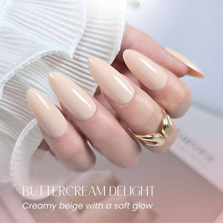 Almond nails painted with Buttercream Delight, styled with a gold ring