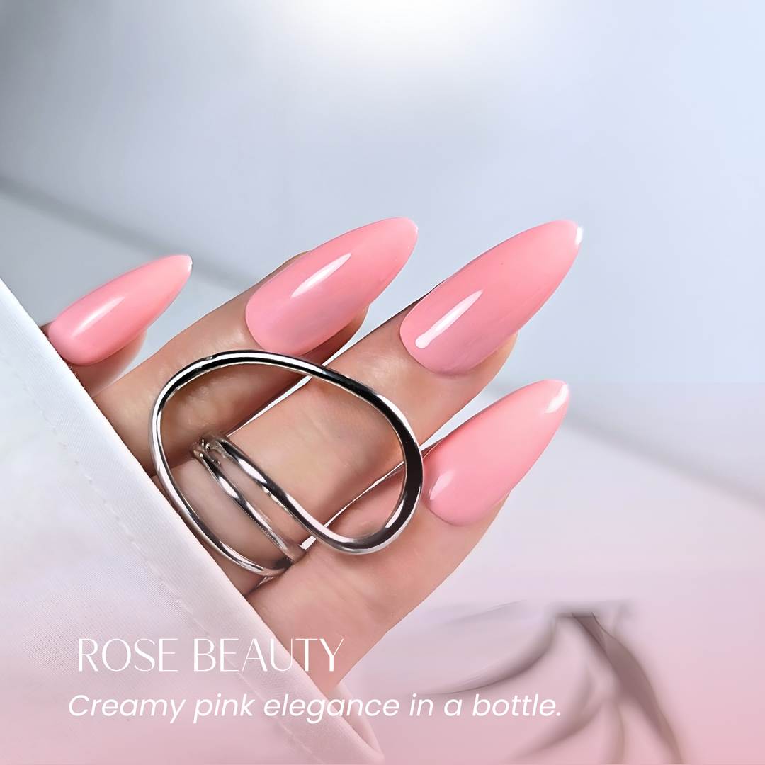 Hand with almond-shaped nails painted in White Diamond Nails 124 Rose Beauty soft pink gel polish.