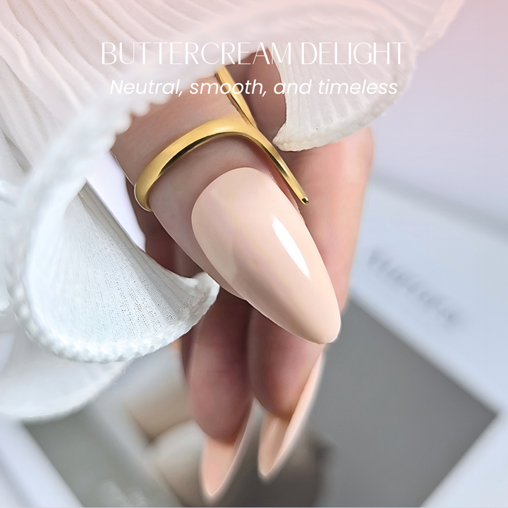 Close-up of thumb nail showing smooth beige gel finish with gold ring