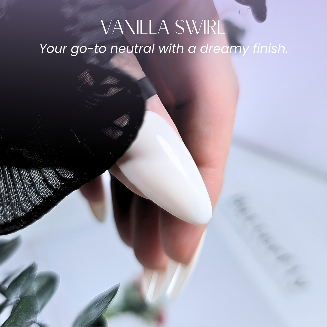 Close-up of creamy vanilla white polish on almond nails.