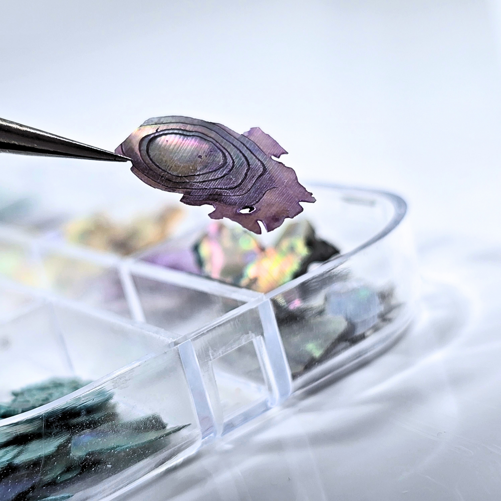 Close-up of a shimmering purple Shell Slice, showcasing its iridescent finish and multi-dimensional shine, perfect for adding a touch of elegance to nail art designs.
