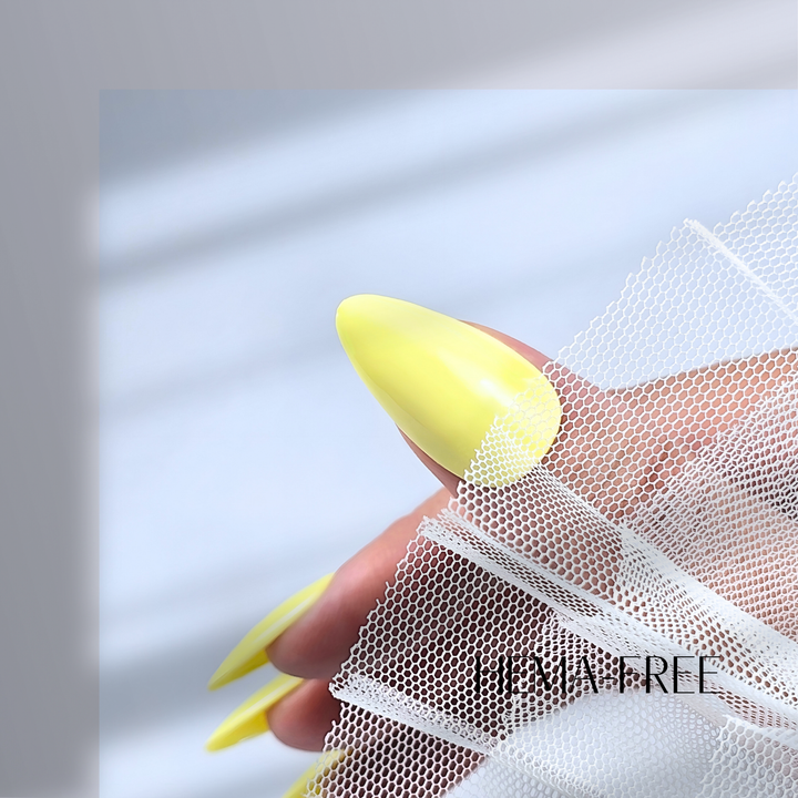 A close-up of a thumb painted with White Diamond Nails gel polish in Lemonade Stand, shade 149, featuring a creamy, pastel yellow hue with a flawless glossy shine, set against a clean, modern background.