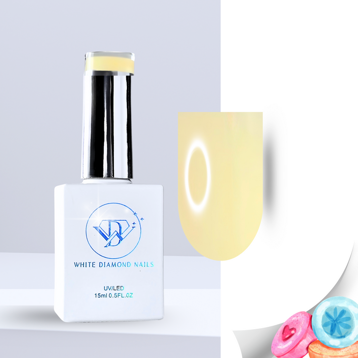 A bottle of White Diamond Nails Marshmallow Glow color base gel, featuring a sleek white design with a chrome cap. The swatch displays a soft, milky yellow hue with a smooth, luminous finish. Pastel-colored candies in the corner emphasize its sweet, marshmallow-inspired scent.