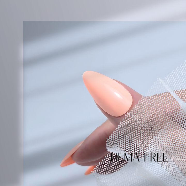 A close-up of a thumb painted with White Diamond Nails gel polish in Spring Meadow, shade 171, featuring a creamy light orange-pink hue with a flawless glossy shine, set against a clean, modern background.