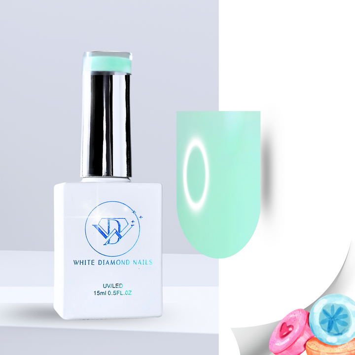 A bottle of White Diamond Nails Marshmallow Mint color base gel, featuring a sleek white design with a chrome cap. The swatch displays a soft, milky mint-green hue with a smooth, luminous finish. Pastel-colored candies in the corner emphasize its sweet, marshmallow-inspired scent.