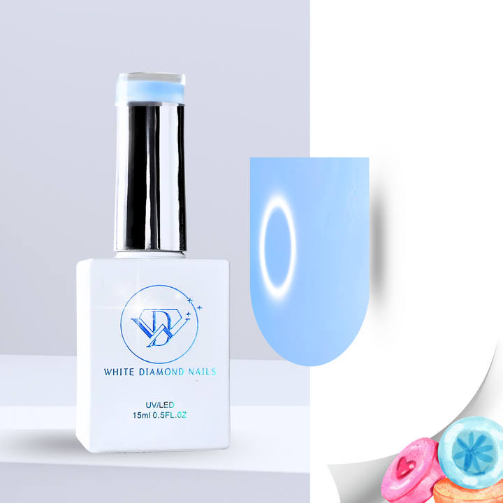 A bottle of White Diamond Nails Icy Marshmallow color base gel, featuring a sleek white design with a chrome cap. The swatch displays a soft, milky blue hue with a smooth, luminous finish. Pastel-colored candies in the corner emphasize its sweet, marshmallow-inspired scent.