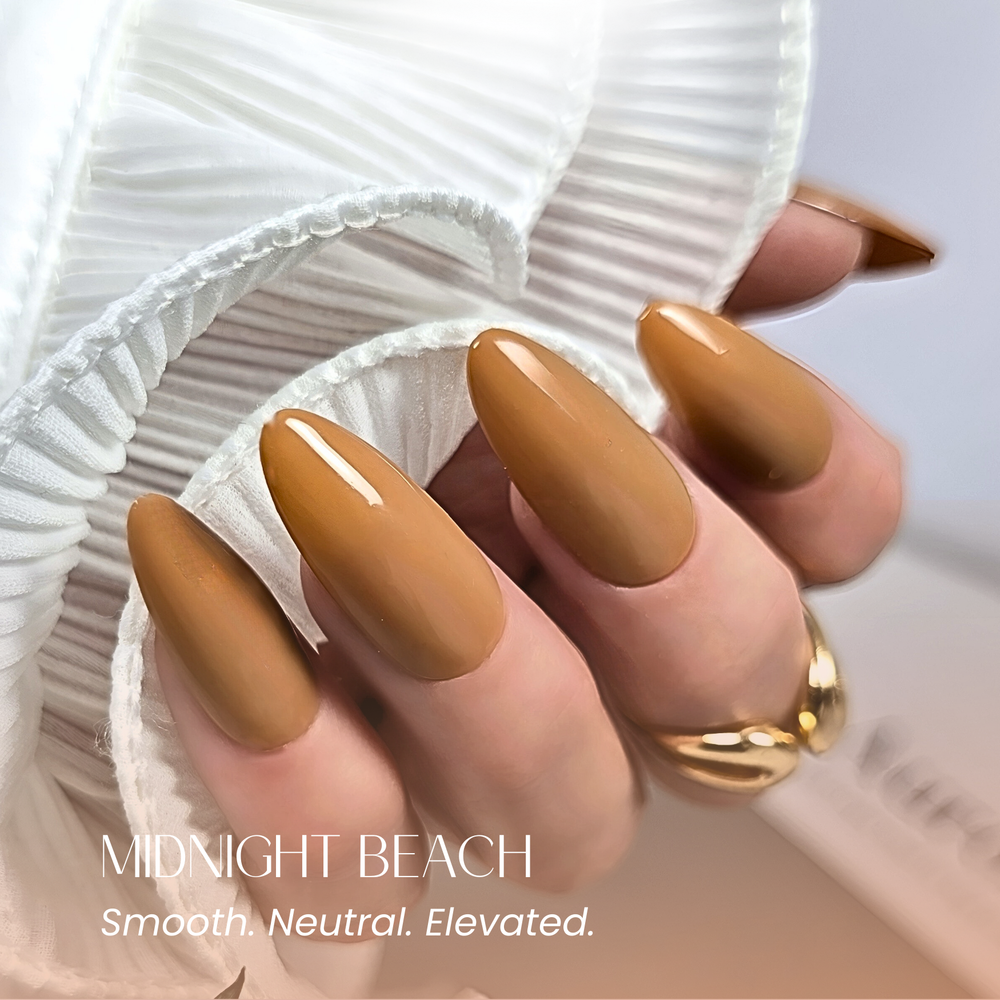 Almond-shaped nails painted in 208 Midnight Beach, styled with a gold ring and neutral background.