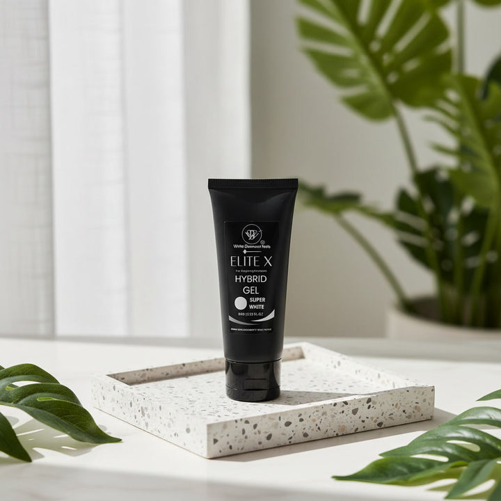 Black tube of Elite X Hybrid Gel on a white surface with green leaves in the background